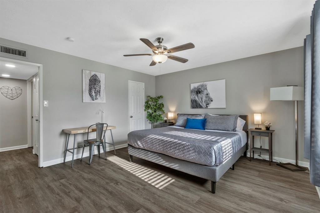 5652 Phelps Street The Colony, TX 75056 - Photo 19 of 29 a bedroom with a bed and a chandelier