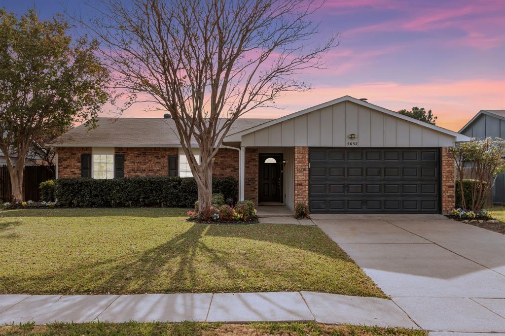 5652 Phelps Street The Colony, TX 75056 - Photo 2 of 29 a front view of a house with yard and garage