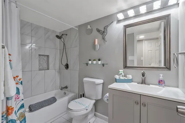 a bathroom with a sink toilet vanity and shower