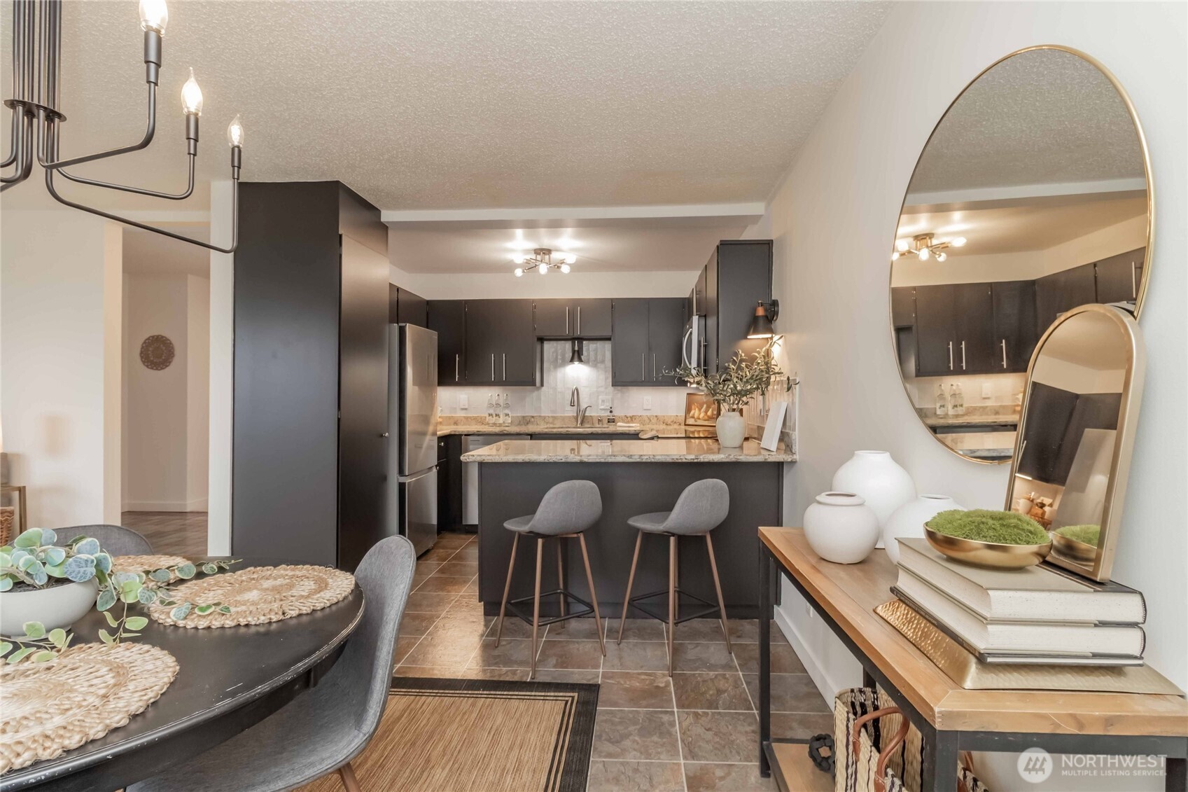 1425 South Puget Drive, Unit O4 Renton, WA 98055 - Photo 16 of 32 a dining room with furniture and a chandelier