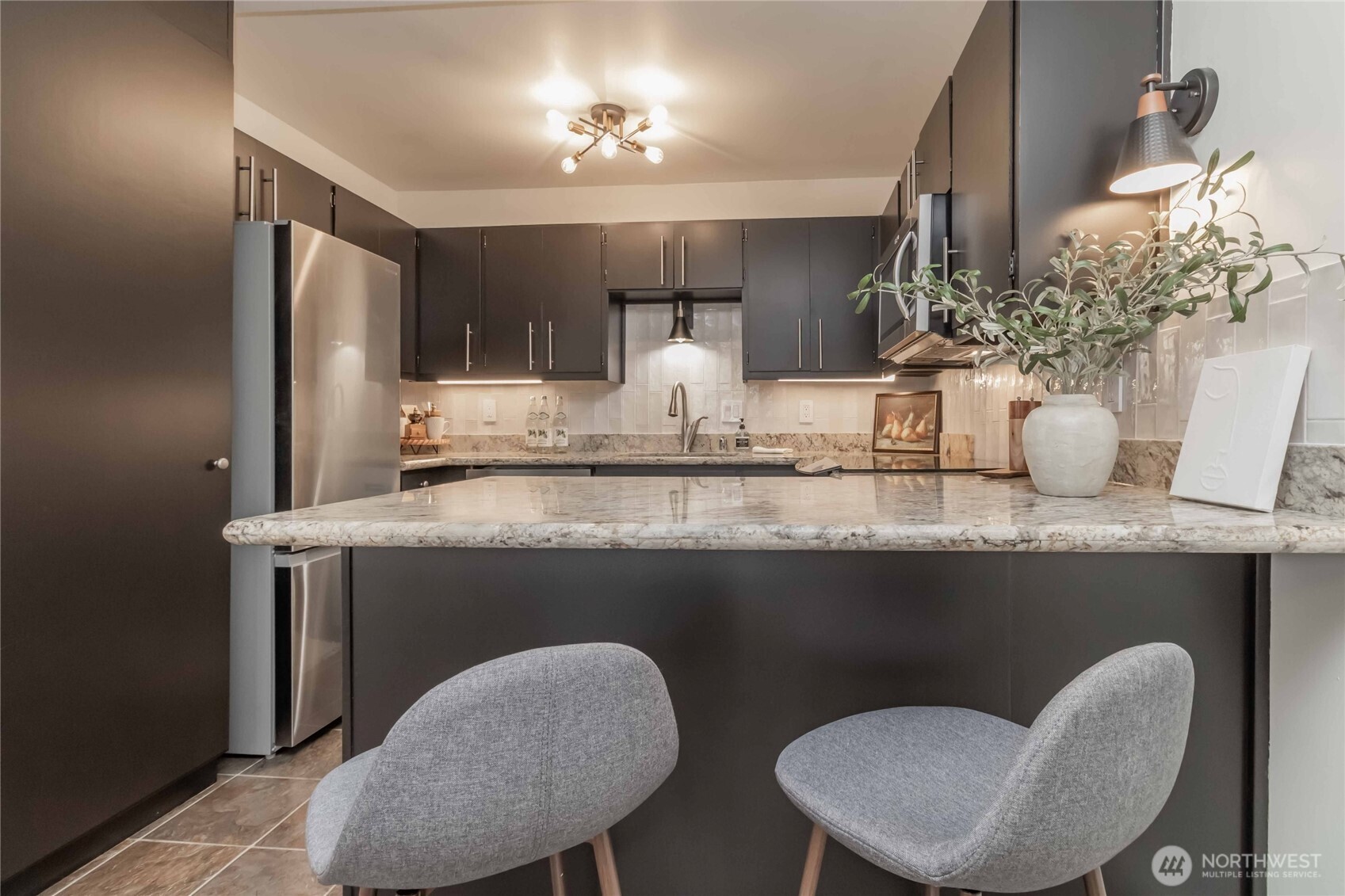 1425 South Puget Drive, Unit O4 Renton, WA 98055 - Photo 18 of 32 a view of dining room kitchen with furniture and chandelier