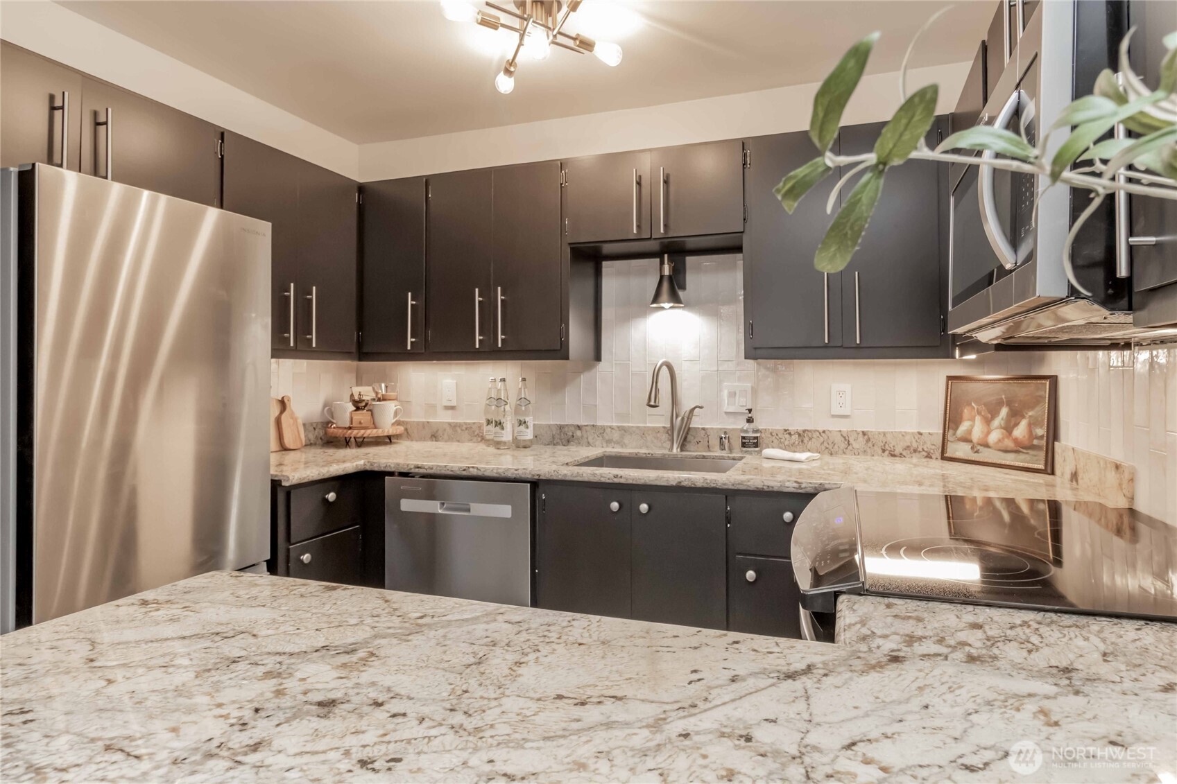1425 South Puget Drive, Unit O4 Renton, WA 98055 - Photo 19 of 32 a kitchen with stainless steel appliances granite countertop a sink refrigerator and cabinets