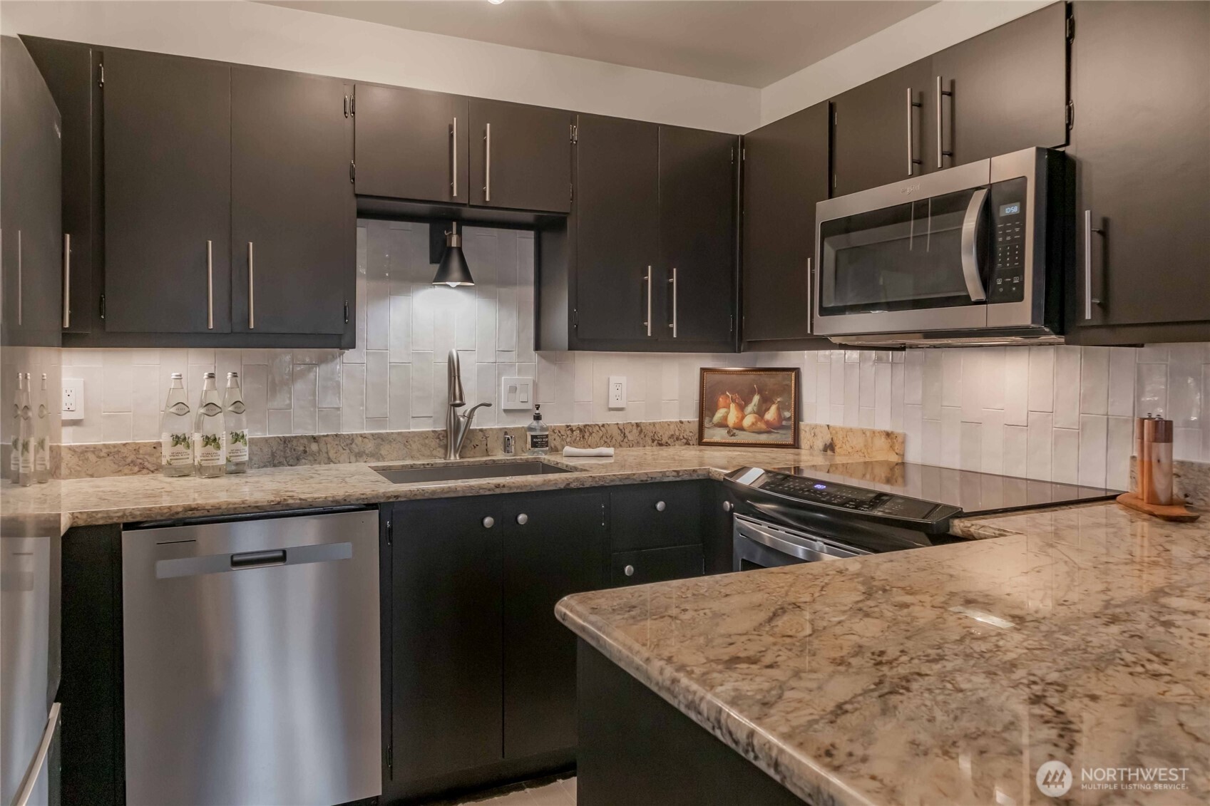 1425 South Puget Drive, Unit O4 Renton, WA 98055 - Photo 20 of 32 a kitchen with stainless steel appliances granite countertop a sink stove and microwave