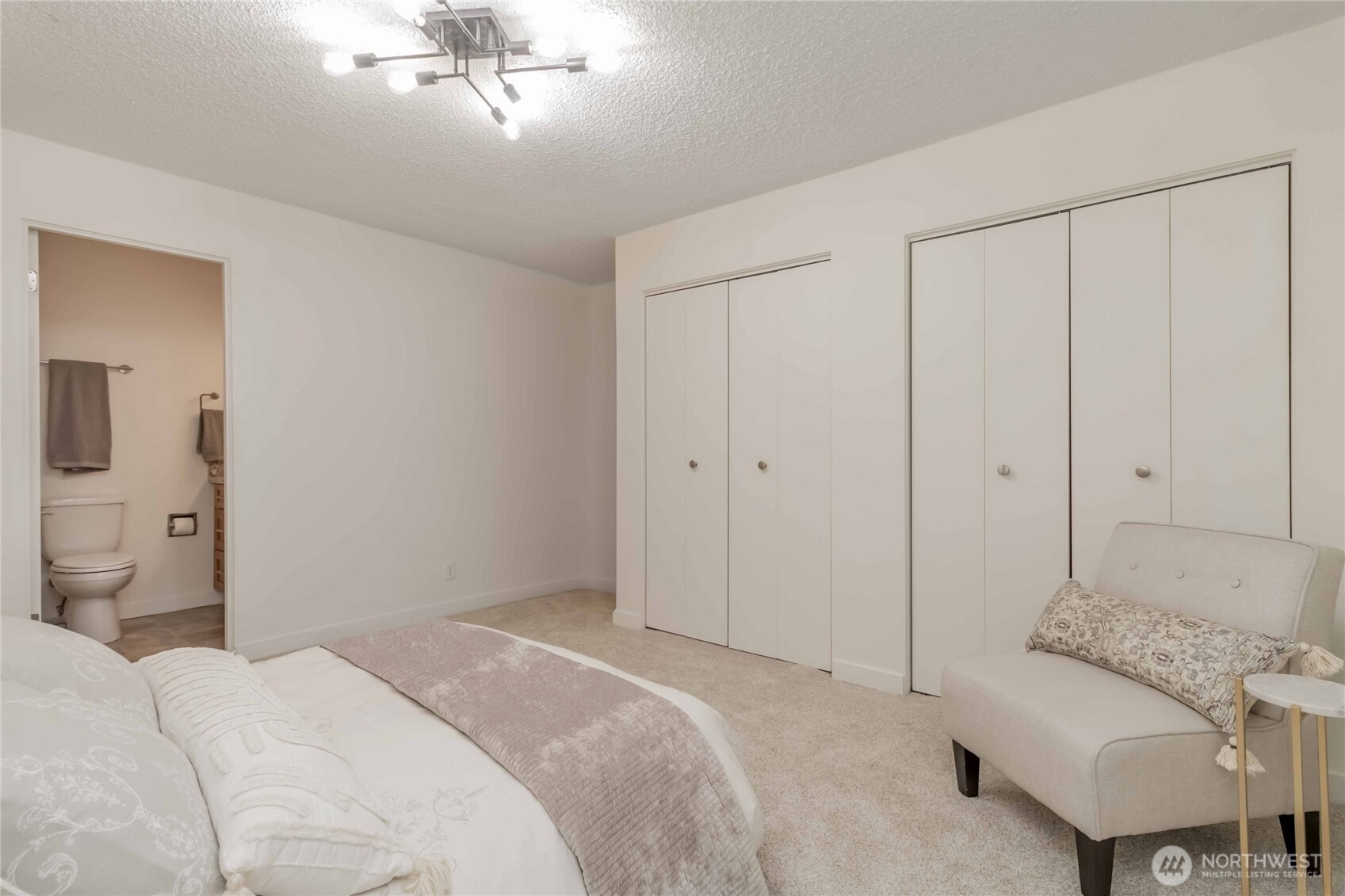 1425 South Puget Drive, Unit O4 Renton, WA 98055 - Photo 25 of 32 a bedroom with a bed and a couch