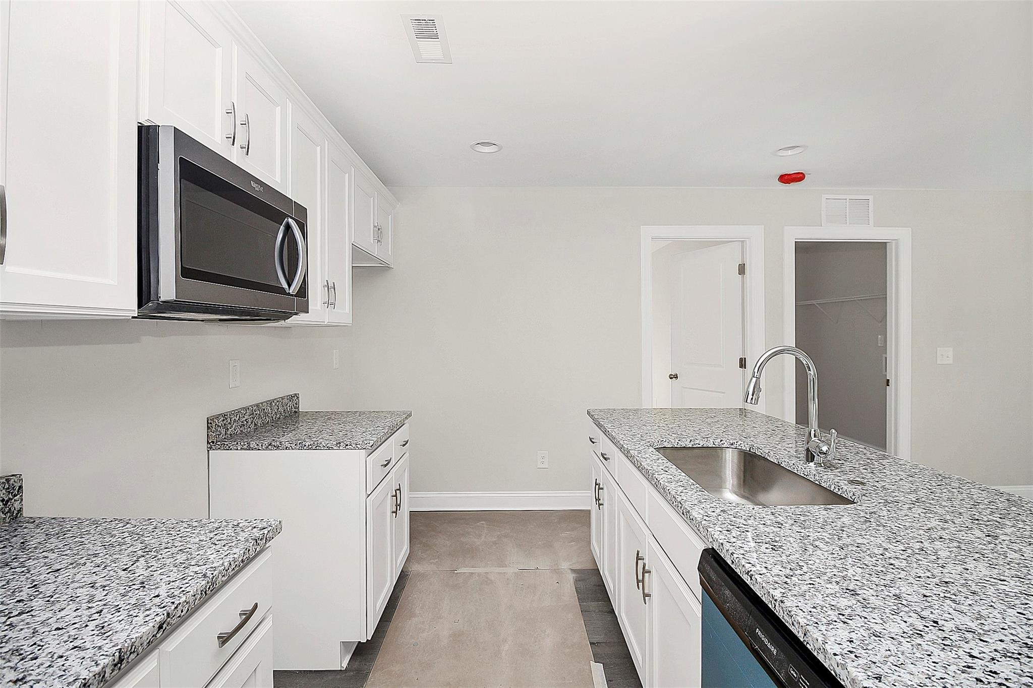 4412 Tillman Road Charlotte, NC 28208 - Photo 16 of 34 a kitchen with stainless steel appliances granite countertop a sink stove and microwave
