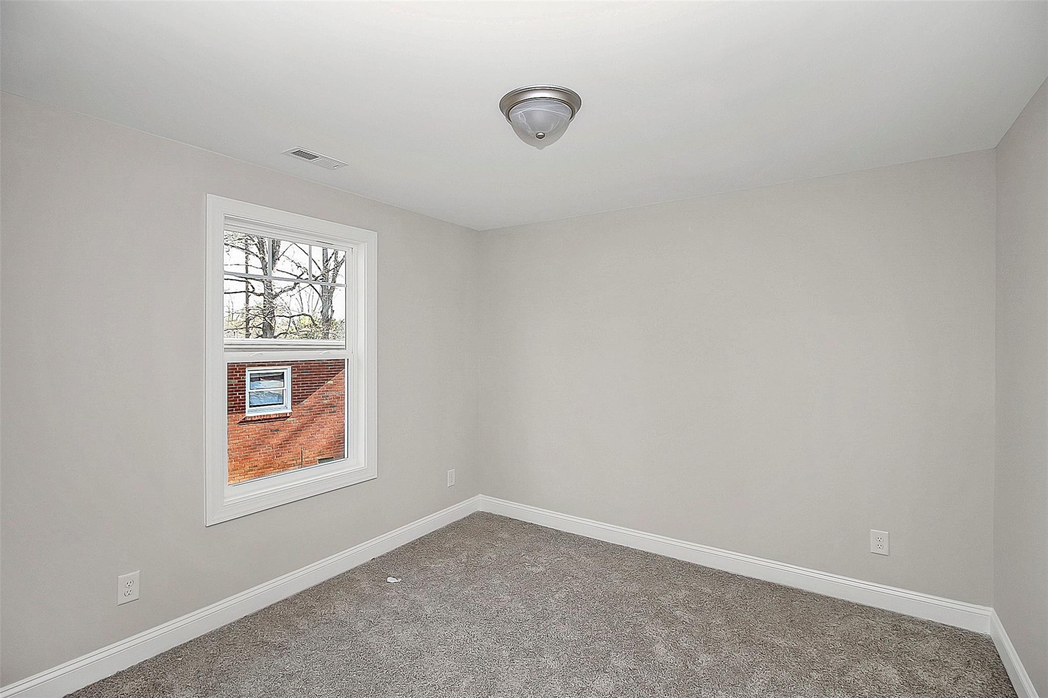 4412 Tillman Road Charlotte, NC 28208 - Photo 29 of 34 an empty room with windows