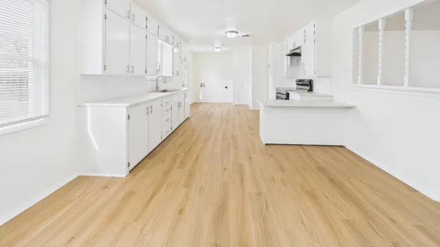a view of a kitchen with wooden floor