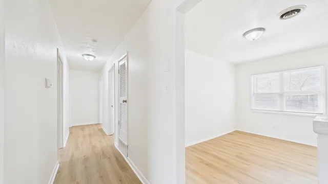 a view of hallway with wooden floor