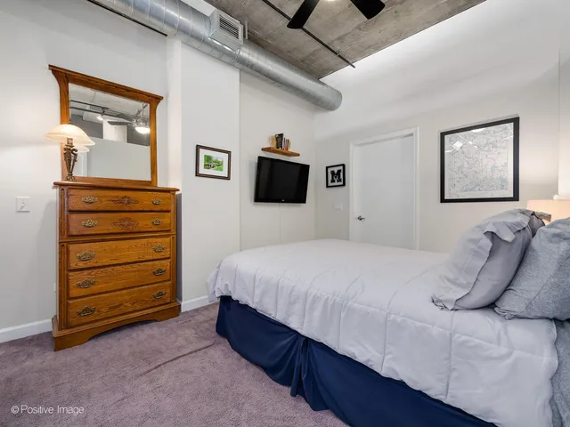 a bedroom with a bed and a dresser