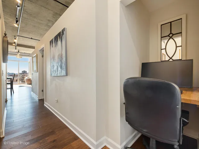 a view of hallway with wooden floor and furniture