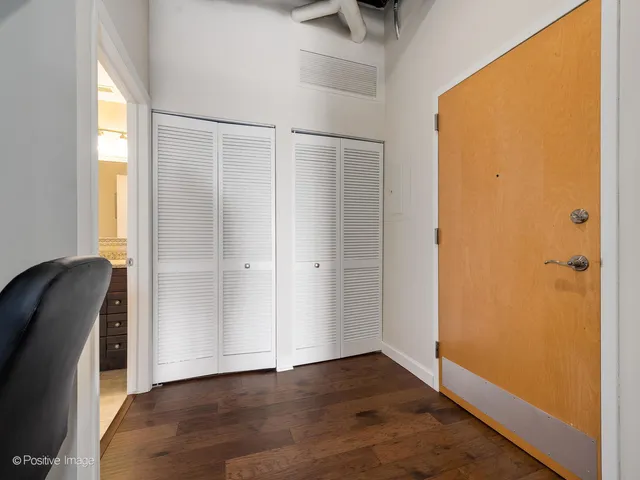 a view of a bedroom with wooden floor and a window