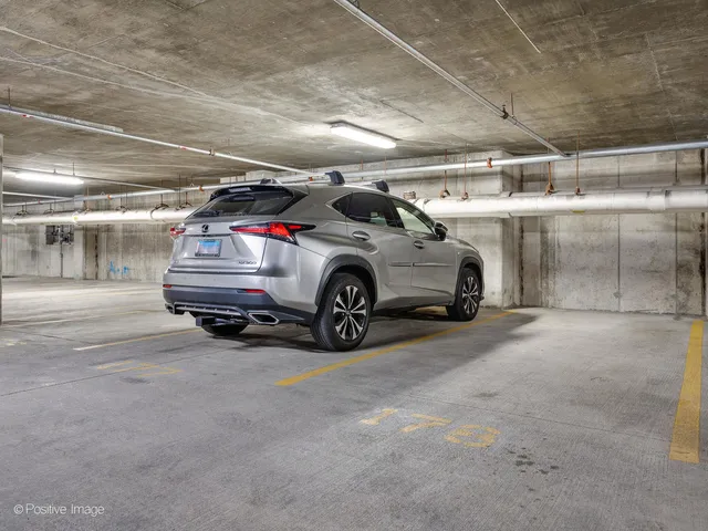 a view of parking garage with cars parked