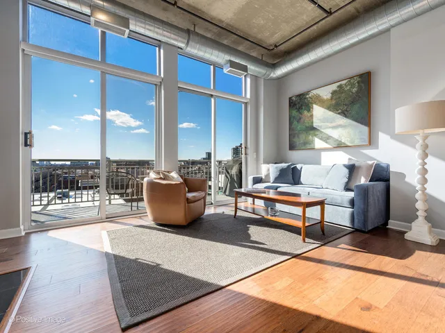 a living room with furniture a rug and a chandelier