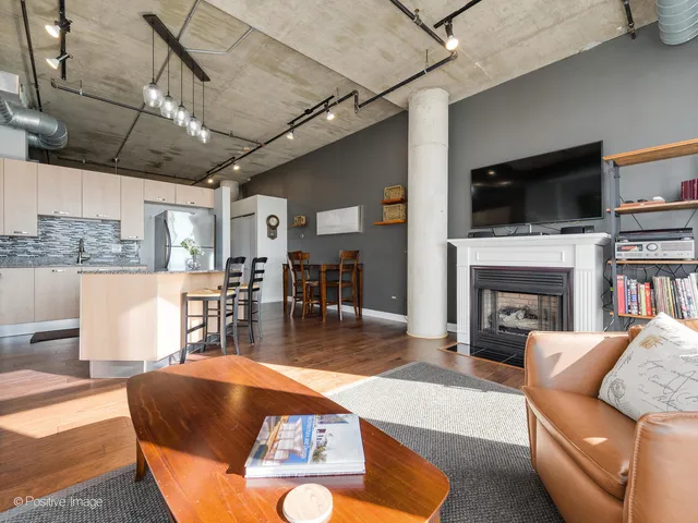 a living room with fireplace furniture and a flat screen tv