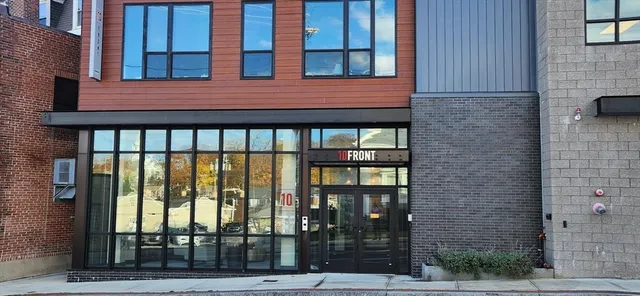 a view of an empty room with a fireplace and a window