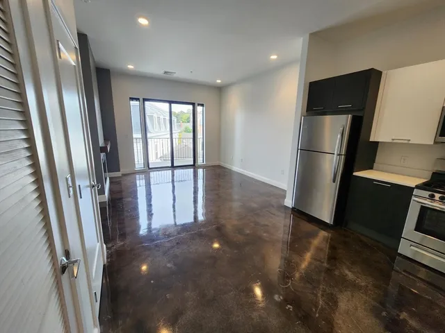 a view of a balcony with wooden floor and outdoor seating