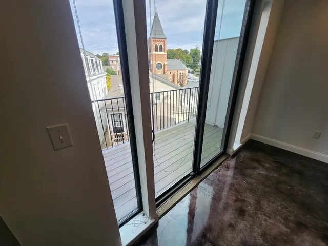 an empty room with a empty space and windows