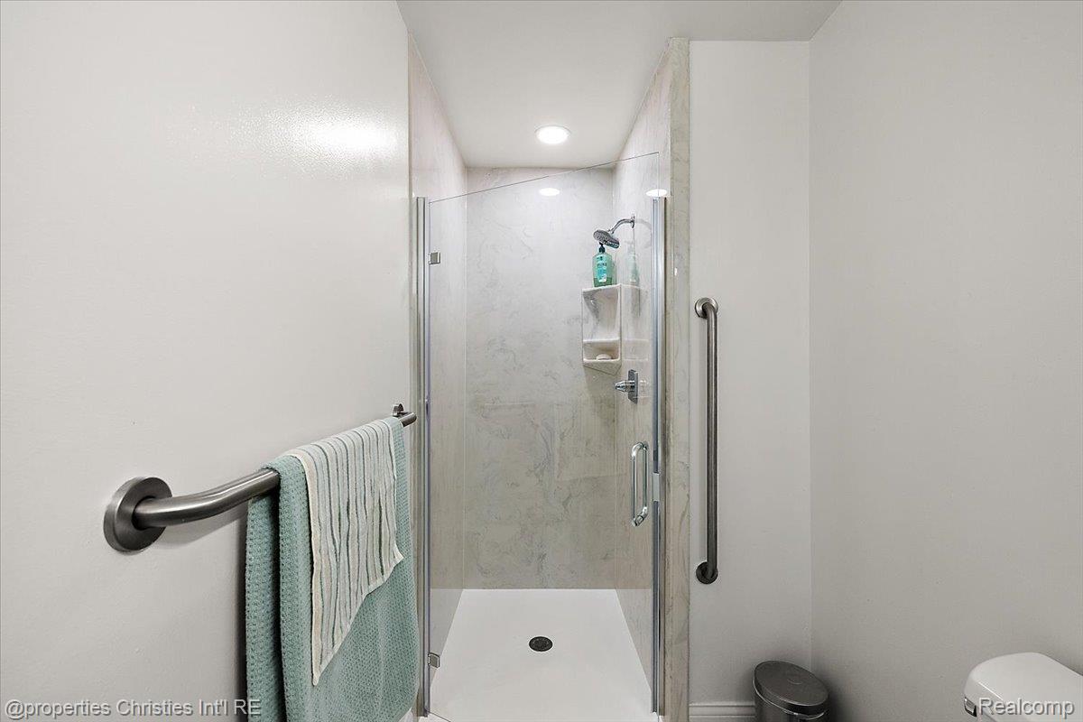 1830 Lone Pine Road Bloomfield Hills, MI 48302 - Photo 18 of 49 Full bathroom featuring toilet and a marble finish shower