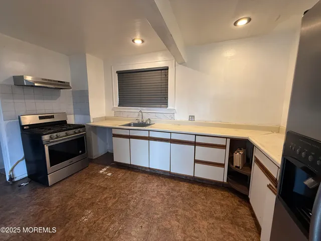 a kitchen with a stove and a microwave