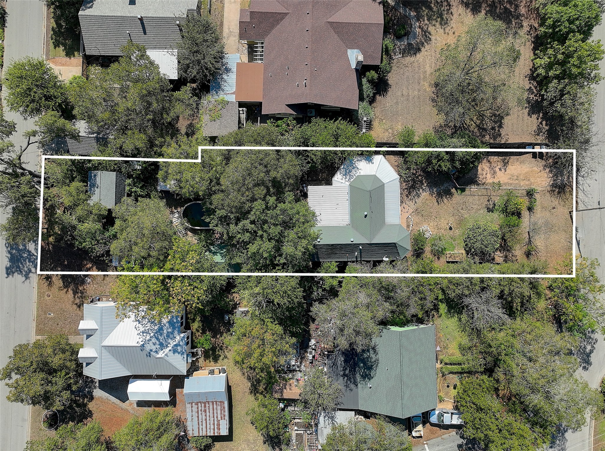 an aerial view of a house with a yard and lake view