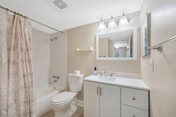 a view of room with window and ceiling fan