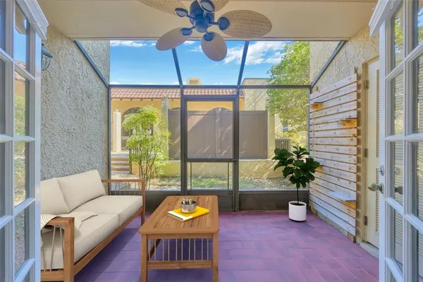 a view of a hallway with a glass door and furniture