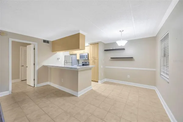 a kitchen with stainless steel appliances granite countertop a sink refrigerator and cabinets