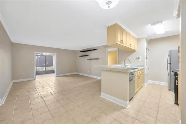 a kitchen with granite countertop a stove a sink and a refrigerator