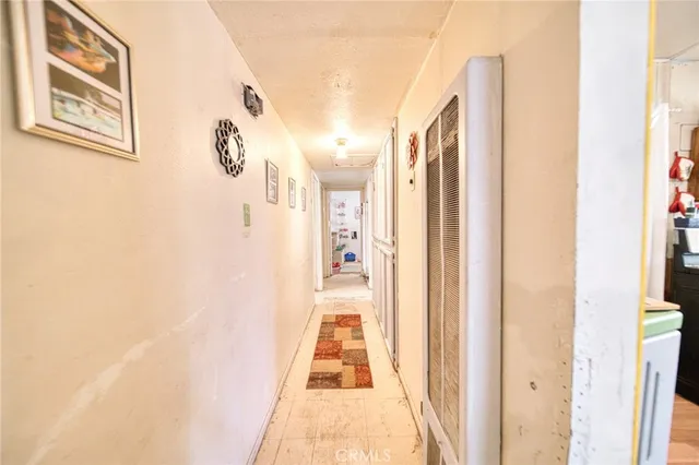 a view of a hallway with wooden floor and dining room
