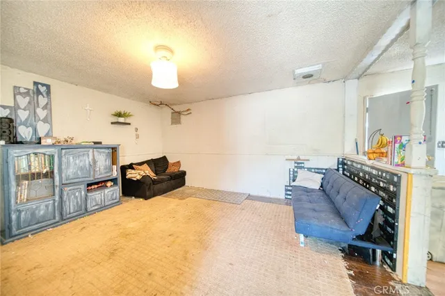 a bed room with furniture and a flat screen tv