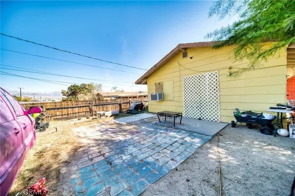 a backyard of a house with barbeque oven table and chairs