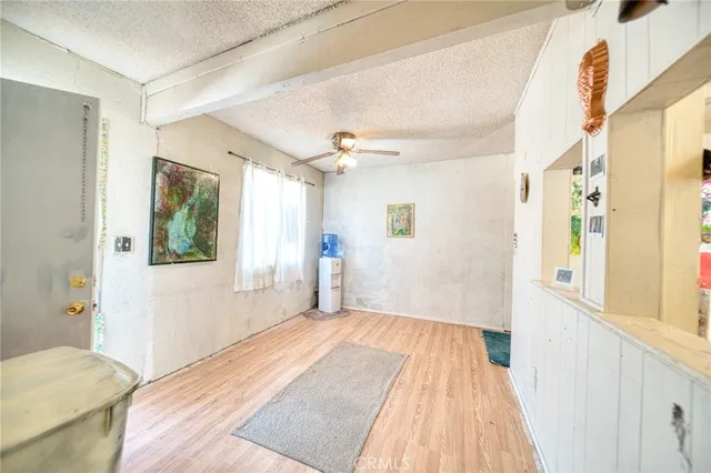 a view of a bedroom with wooden floor and windows