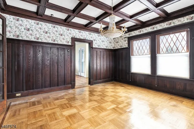 a view of a livingroom with wooden floor and a ceiling fan