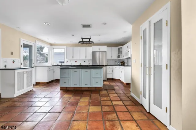 a kitchen with stainless steel appliances granite countertop a sink and cabinets