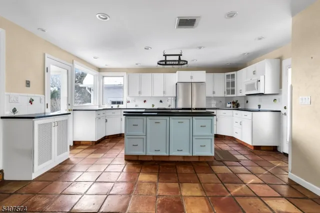 a kitchen with stainless steel appliances a sink cabinets and a counter top space