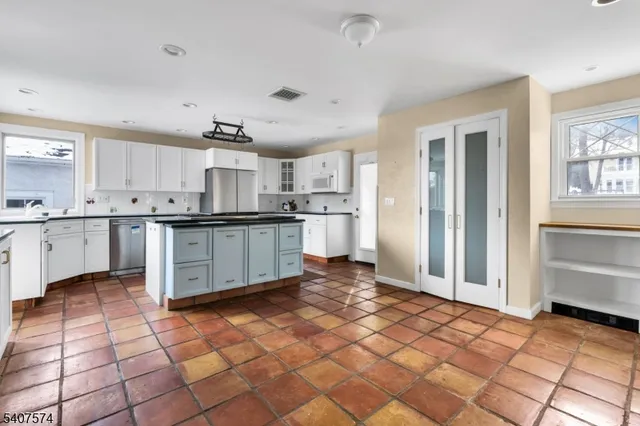 a kitchen with stainless steel appliances granite countertop a sink and cabinets