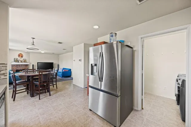 a kitchen with stainless steel appliances a refrigerator and a stove top oven