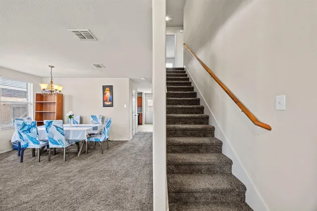 a view of a dining room with furniture and stairs
