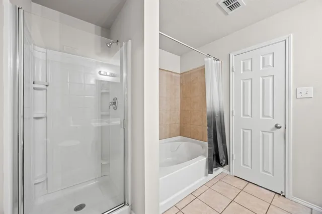 a bathroom with a bathtub and shower