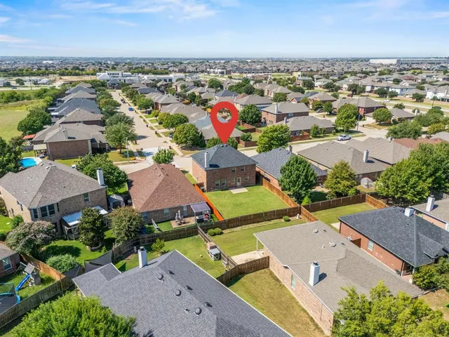 an aerial view of residential houses with outdoor space