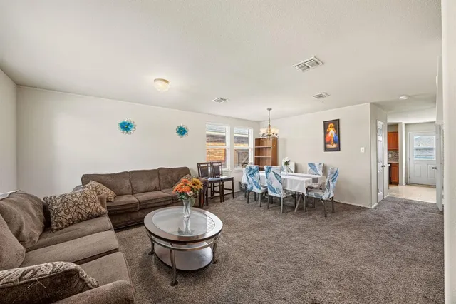 a living room with furniture a window and a table