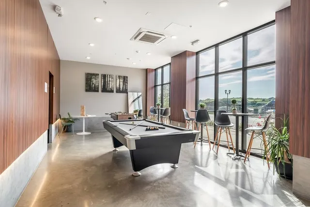 a room with stainless steel appliances lots of counter top space and furniture