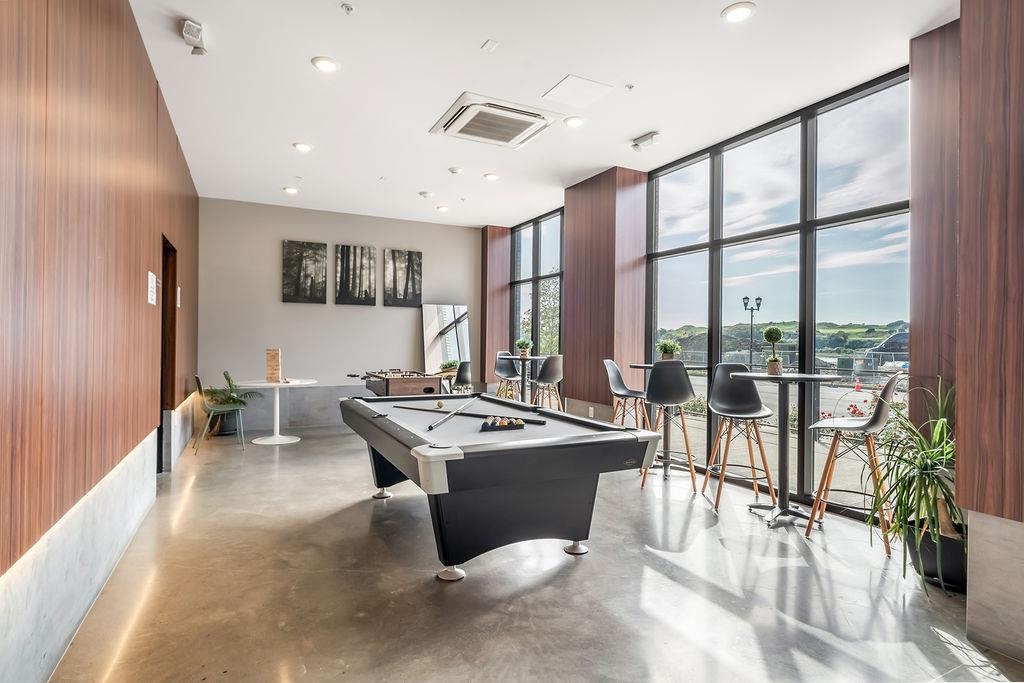 a room with stainless steel appliances lots of counter top space and furniture