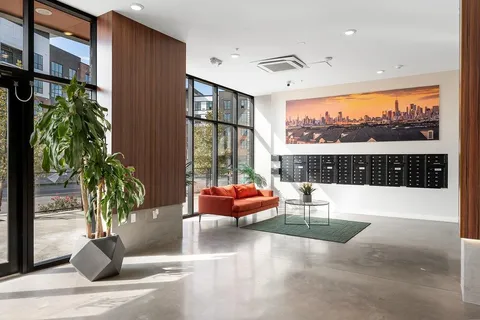 a living room with patio furniture and a potted plant