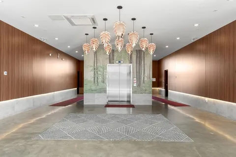 a view of a hallway with chandelier