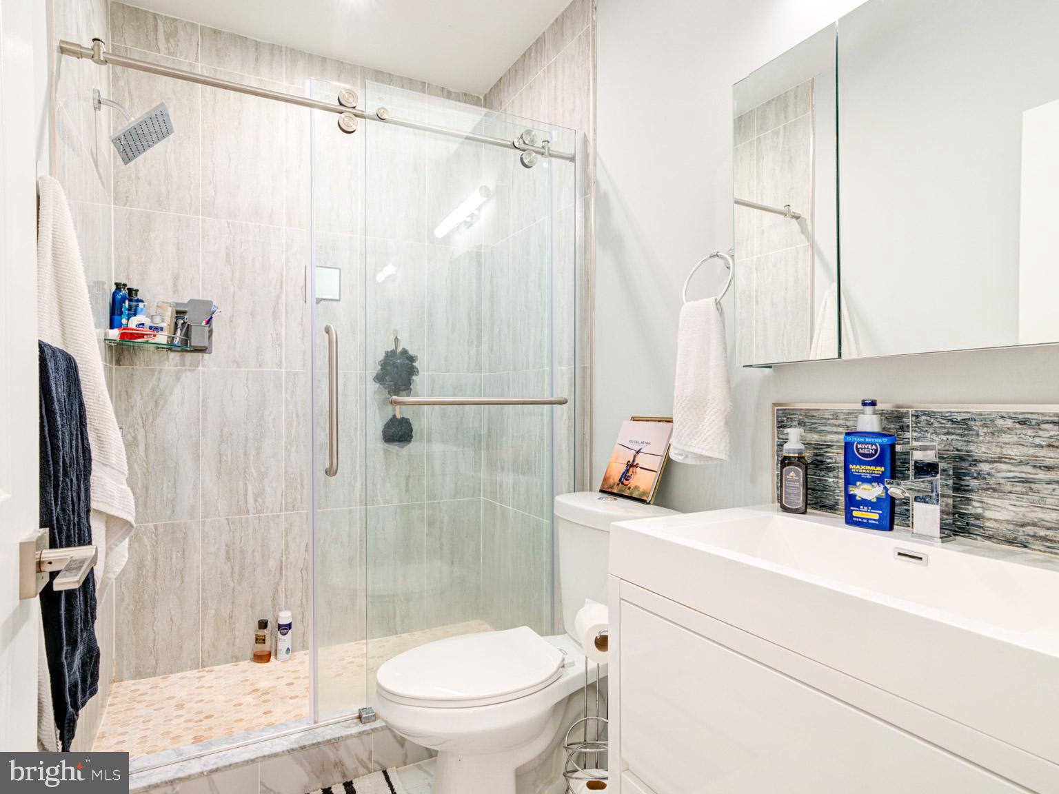 2639 Jasper Street Philadelphia, PA 19125 - Photo 11 of 23 a bathroom with a sink a toilet and a shower curtain