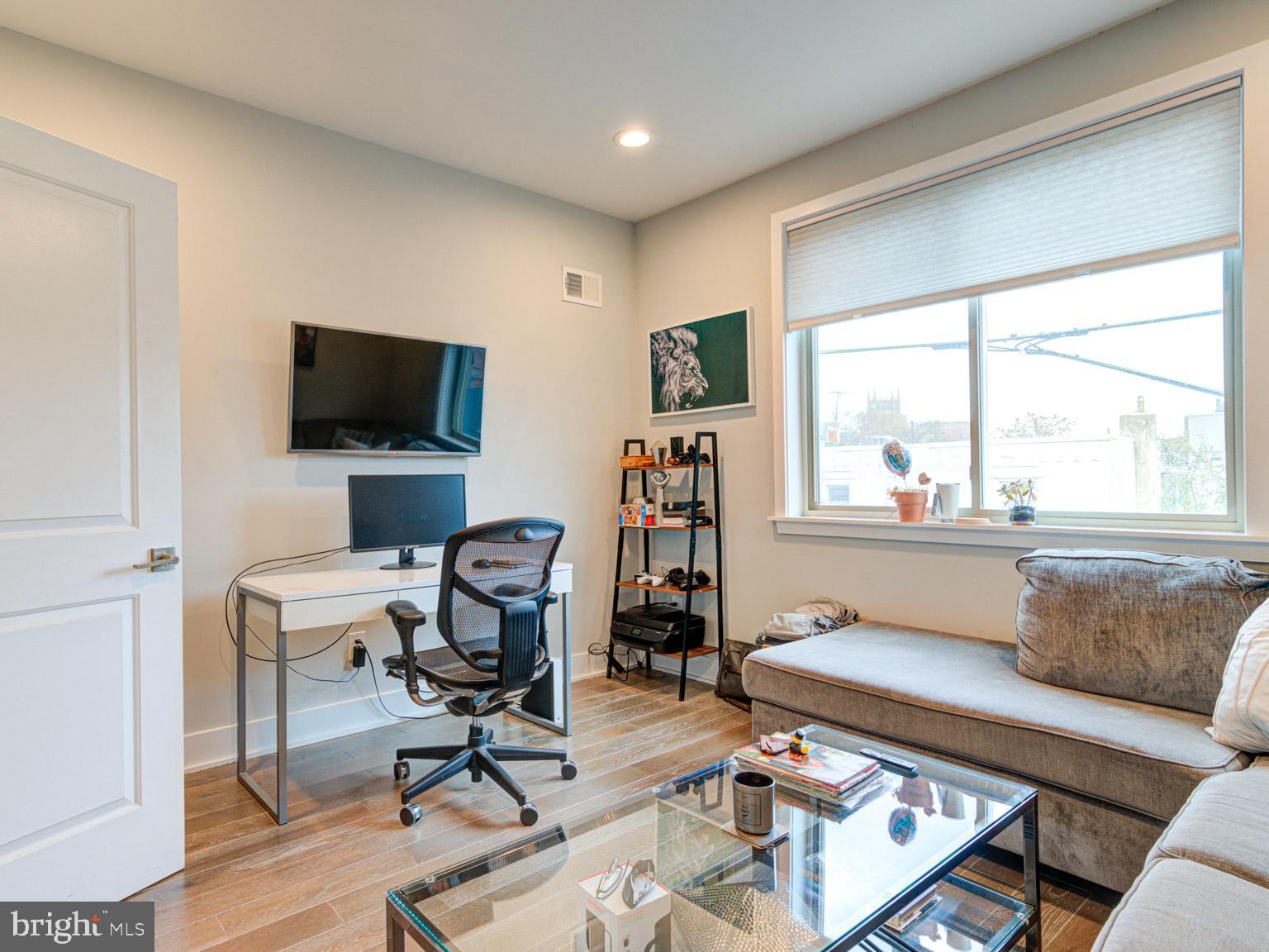 2639 Jasper Street Philadelphia, PA 19125 - Photo 15 of 23 a livingroom with workspace and a window
