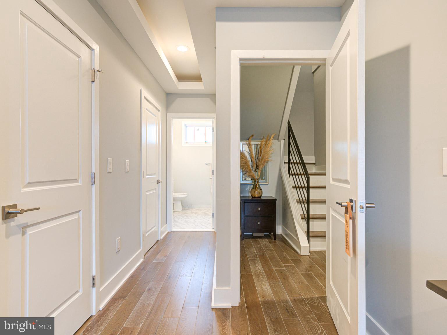 2639 Jasper Street Philadelphia, PA 19125 - Photo 16 of 23 a view of a hallway with wooden floor and staircase
