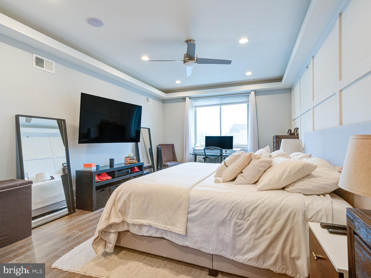 2639 Jasper Street Philadelphia, PA 19125 - Photo 18 of 23 a bedroom with a bed and a flat screen tv