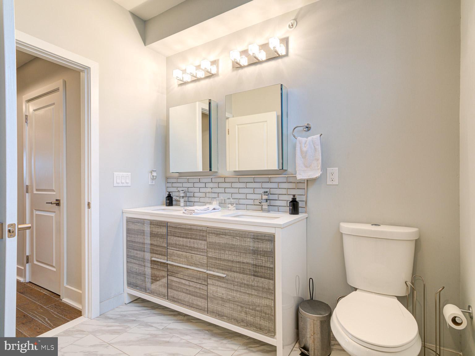 2639 Jasper Street Philadelphia, PA 19125 - Photo 19 of 23 a bathroom with a toilet a sink and mirror